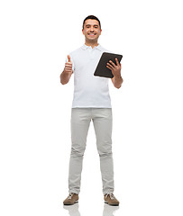 Image showing smiling man with tablet pc showing thumbs up