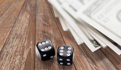 Image showing close up of black dice and dollar cash money