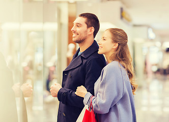 Image showing happy young couple with shopping bags in mall