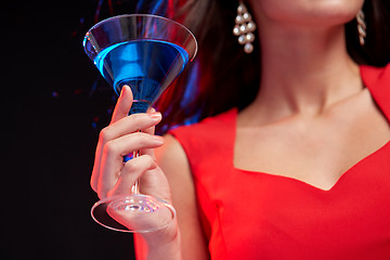 Image showing close up of woman with cocktail at nightclub