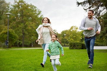 Image showing happy family walking in summer park