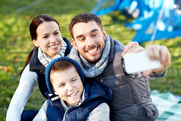 Image showing family with smartphone taking selfie at campsite