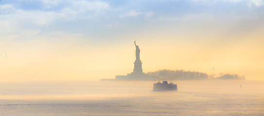 Image showing Staten Island Ferry cruises past the Statue of Liberty.