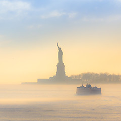 Image showing Staten Island Ferry cruises past the Statue of Liberty.