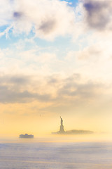 Image showing Staten Island Ferry cruises past the Statue of Liberty.