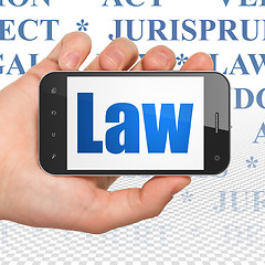 Image showing Law concept: Hand Holding Smartphone with Law on display