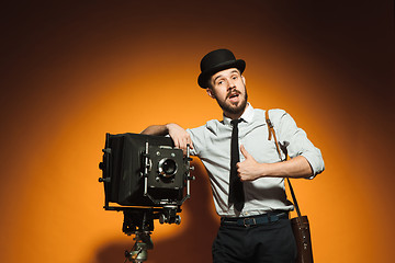 Image showing young man with retro camera 