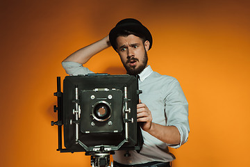 Image showing young man with retro camera 