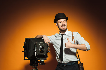 Image showing young man with retro camera 