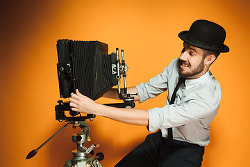 Image showing young man with retro camera 