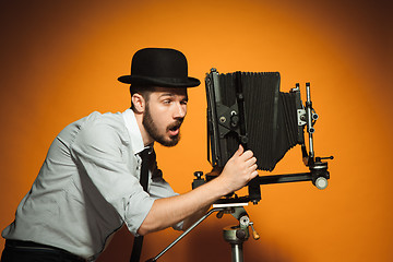 Image showing young man with retro camera 