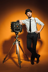 Image showing young man with retro camera 