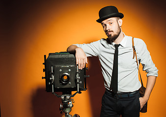 Image showing young man with retro camera 