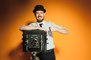 Image showing young man with retro camera 