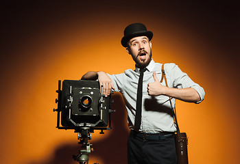 Image showing young man with retro camera 