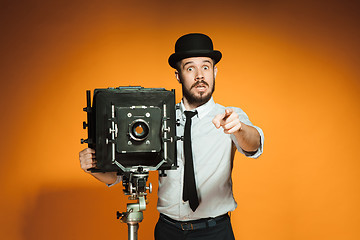 Image showing young man with retro camera 