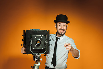 Image showing young man with retro camera 