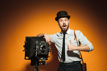 Image showing young man with retro camera 