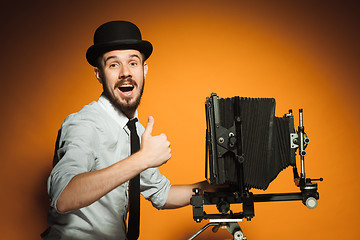 Image showing young man with retro camera 