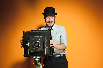 Image showing young man with retro camera 