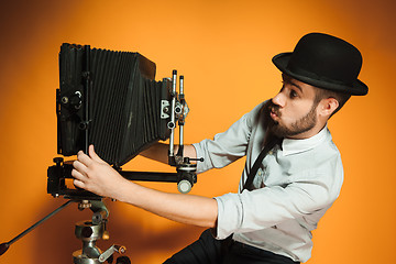 Image showing young man with retro camera 