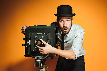 Image showing young man with retro camera 