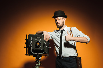 Image showing young man with retro camera 