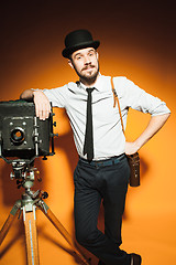 Image showing young man with retro camera 