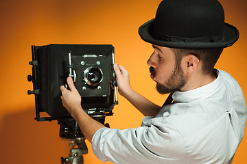 Image showing young man with retro camera 