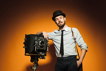 Image showing young man with retro camera 