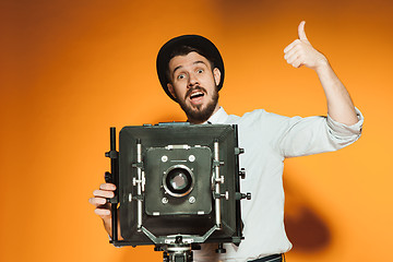 Image showing young man with retro camera 