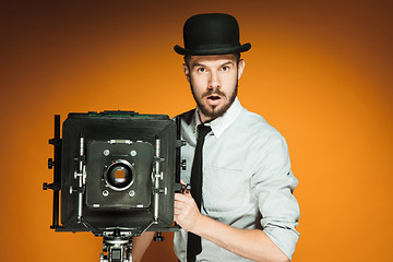 Image showing young man with retro camera 