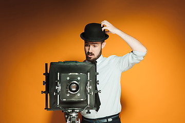 Image showing young man with retro camera 