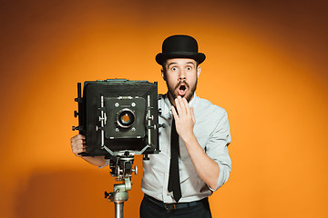 Image showing young man with retro camera 