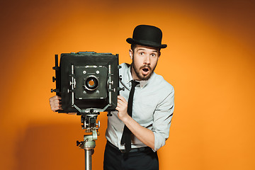 Image showing young man with retro camera 