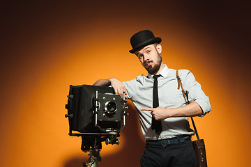Image showing young man with retro camera 