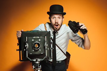 Image showing young man with retro camera 