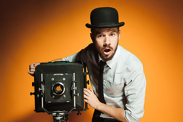 Image showing young man with retro camera 