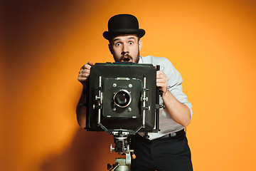 Image showing young man with retro camera 