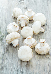 Image showing The champignons on wooden background