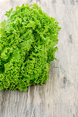 Image showing lettuce salad on a  wood background