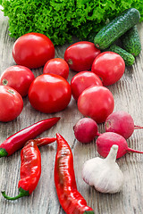 Image showing The multicolored vegetables on wooden table