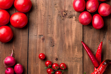 Image showing The red vegetables on wooden table