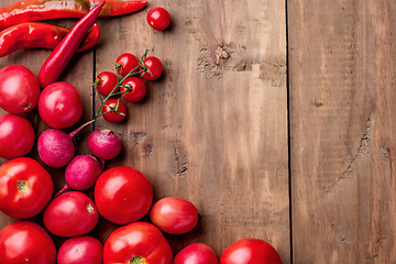 Image showing The red vegetables on wooden table