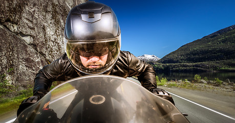 Image showing Biker racing on the road