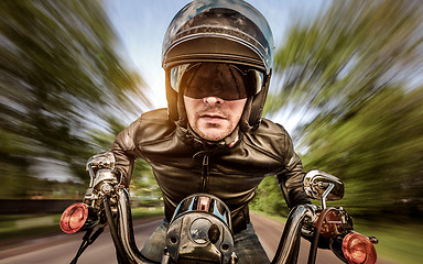 Image showing Biker racing on the road