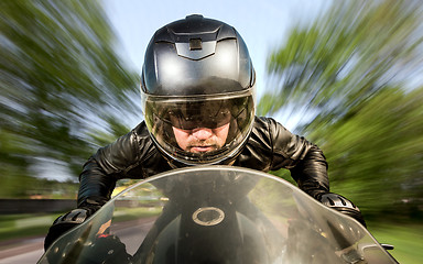 Image showing Biker racing on the road