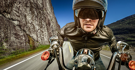 Image showing Biker racing on the road