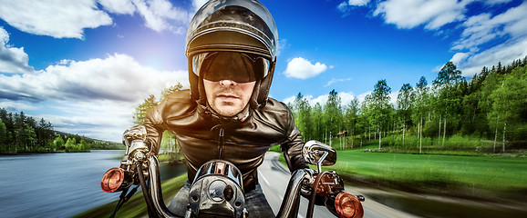 Image showing Biker racing on the road