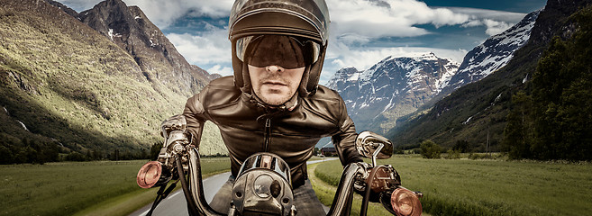 Image showing Biker racing on the road